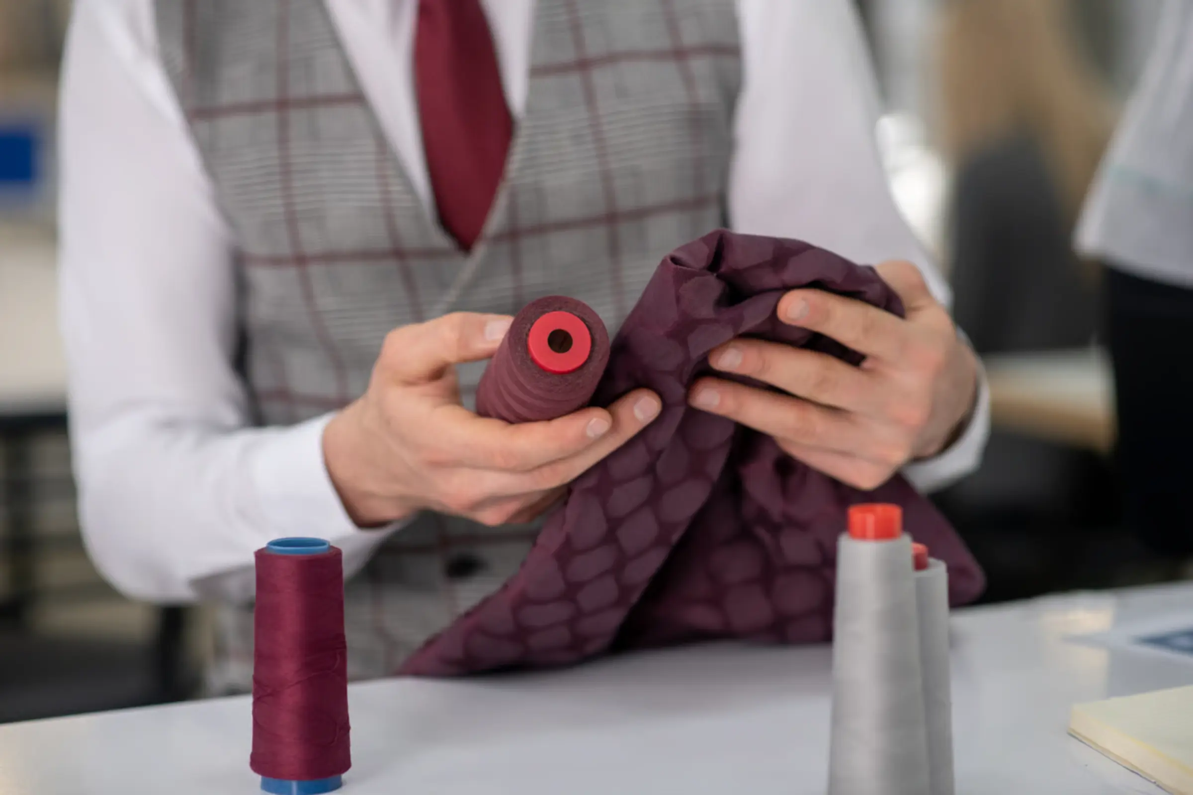 Quality technician comparing a bulk production garment against an approved sample