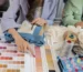 Brand representative reviewing tech pack and fabric swatches with an OEM clothing manufacturer